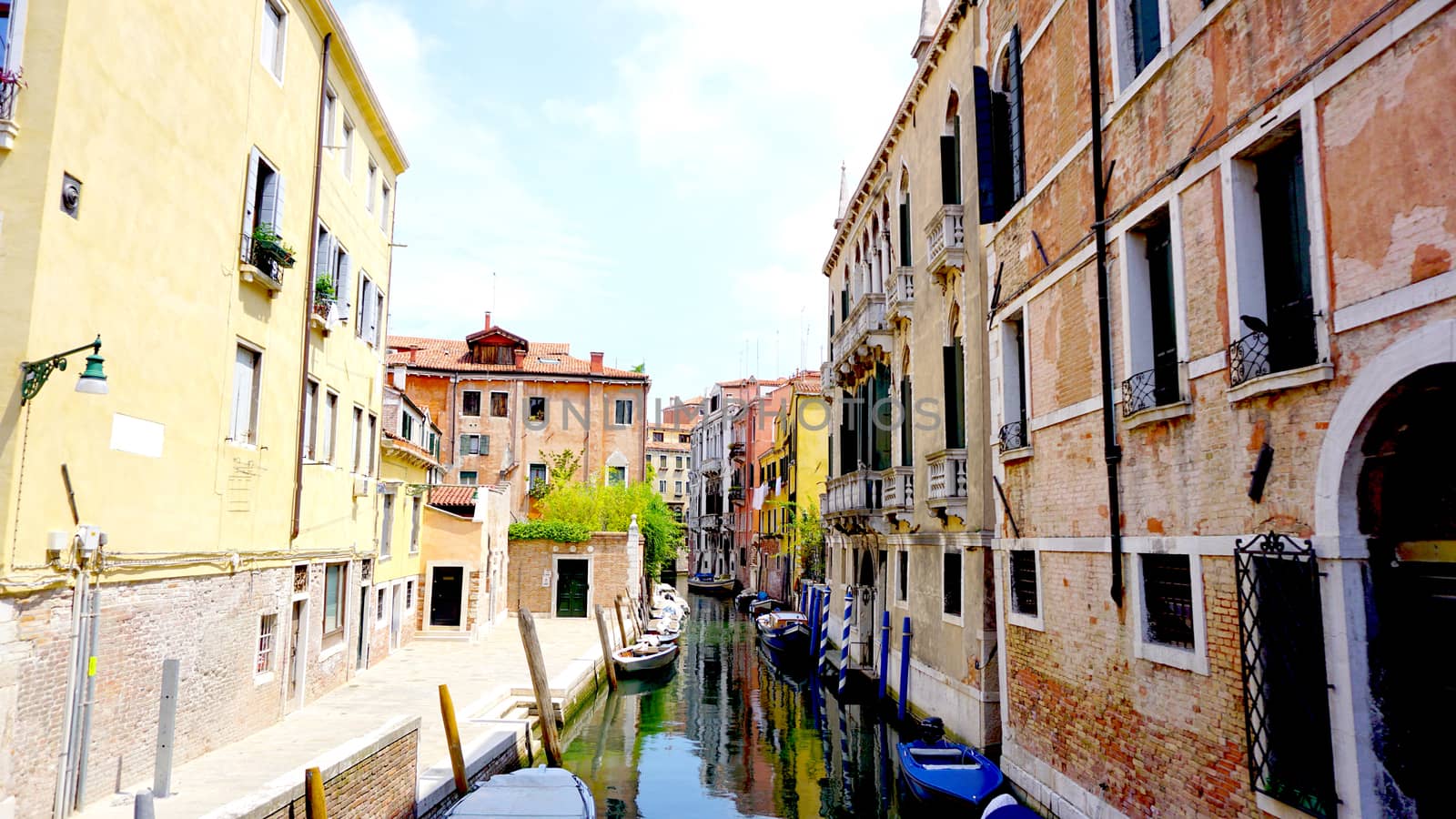 canal and boats with ancient architecture Venice by polarbearstudio