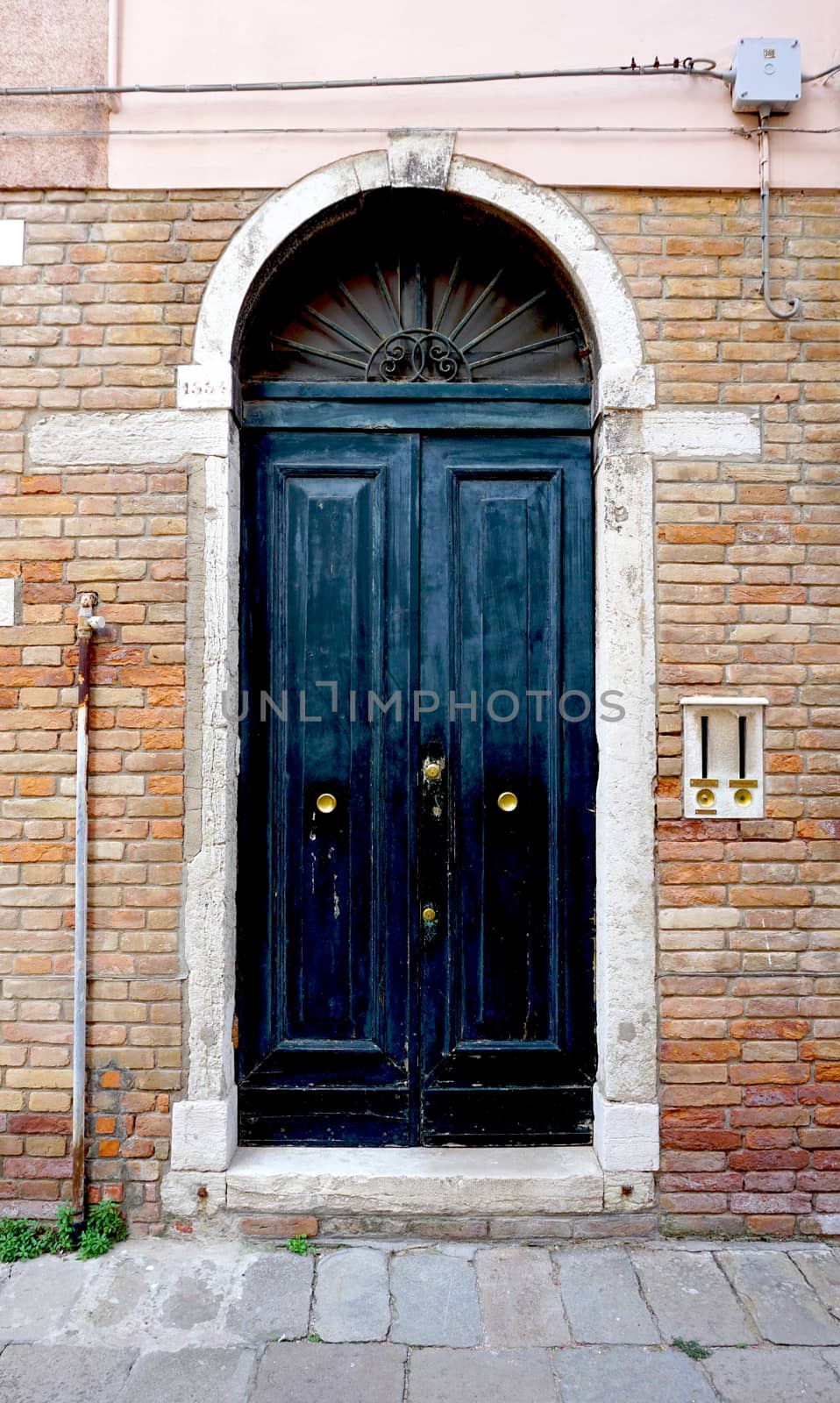 door on old brick wall building  by polarbearstudio