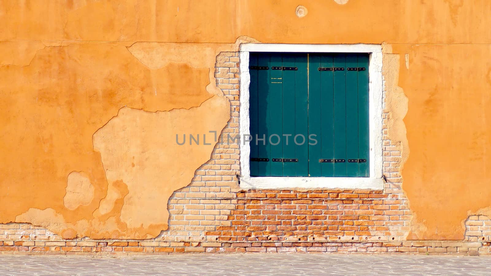green Window on yellow and brick wall building architecture, Venice, Italy