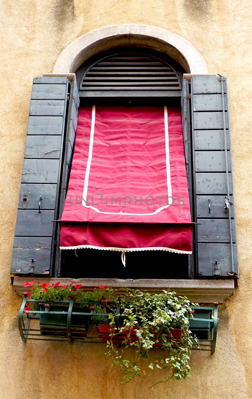 Window, red canopy and old wall building architecture, Venice, Italy