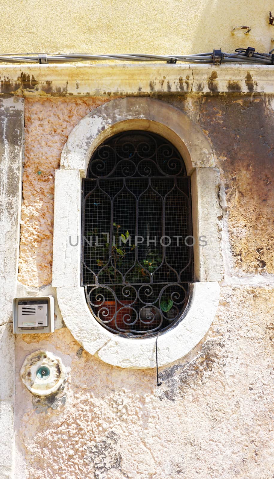 oval shape window of old house building in Venice, Italy