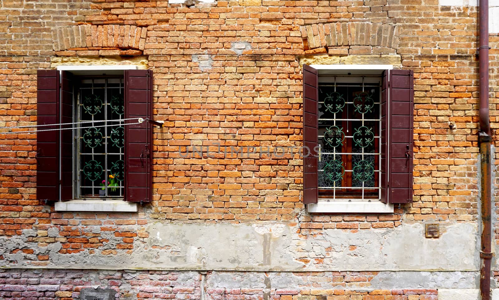 two windows with brick decay wall building  by polarbearstudio