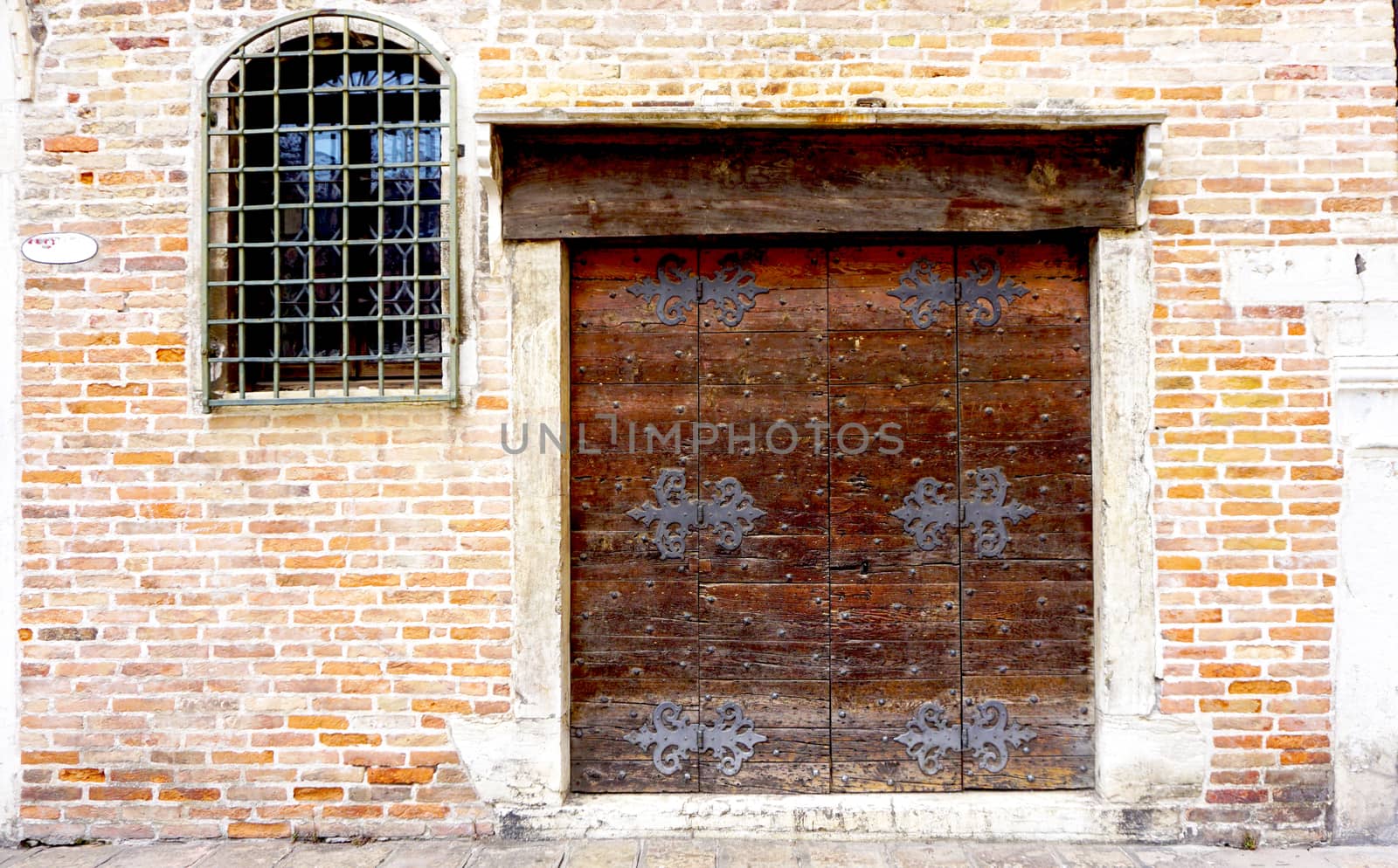 wooden door with brick wall building architecture in Venice, Italy