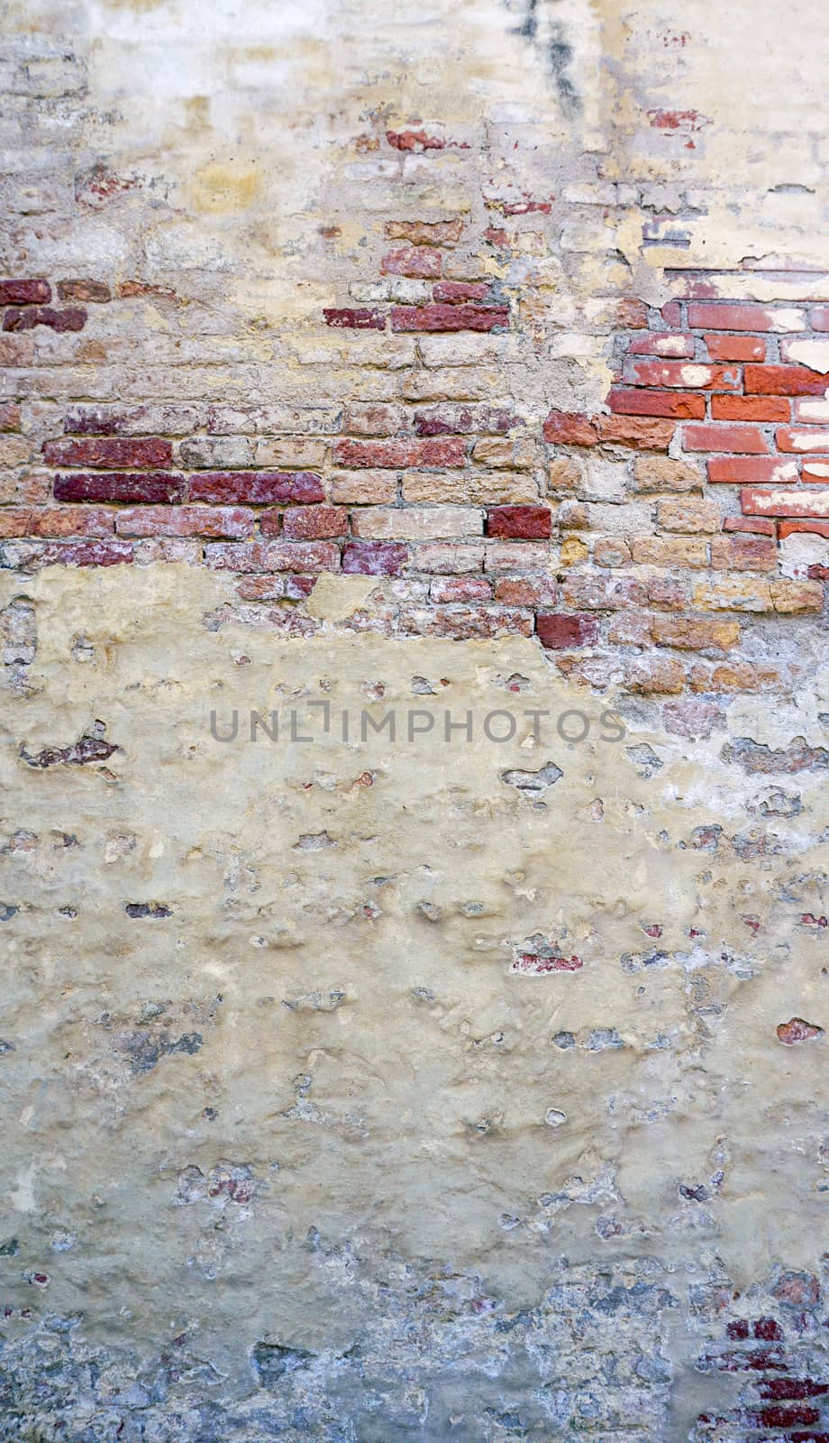 decay wall mixed with brick background vetical in Venice, Italy