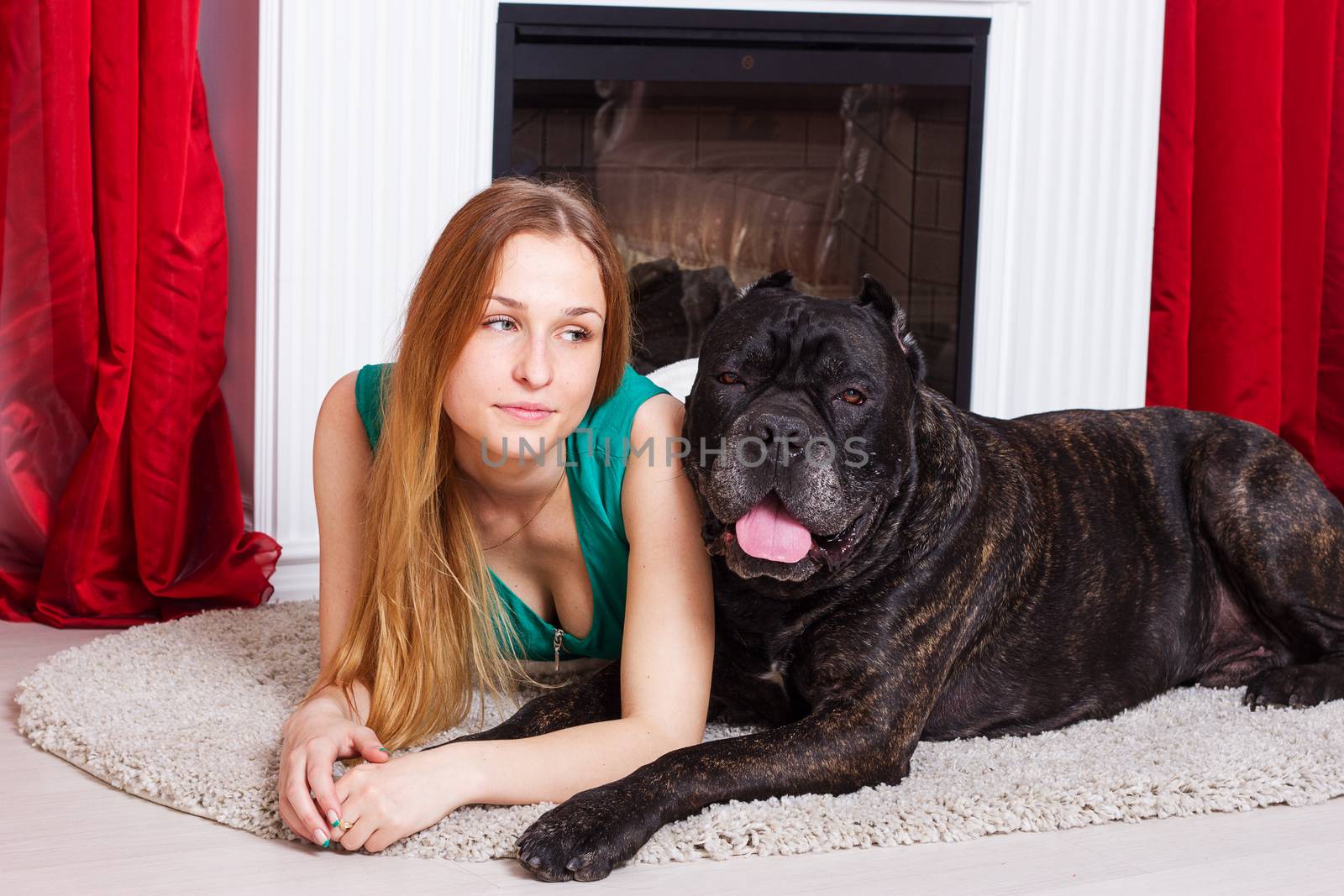 girl is at home next to the fireplace with dog Cane Corso by victosha