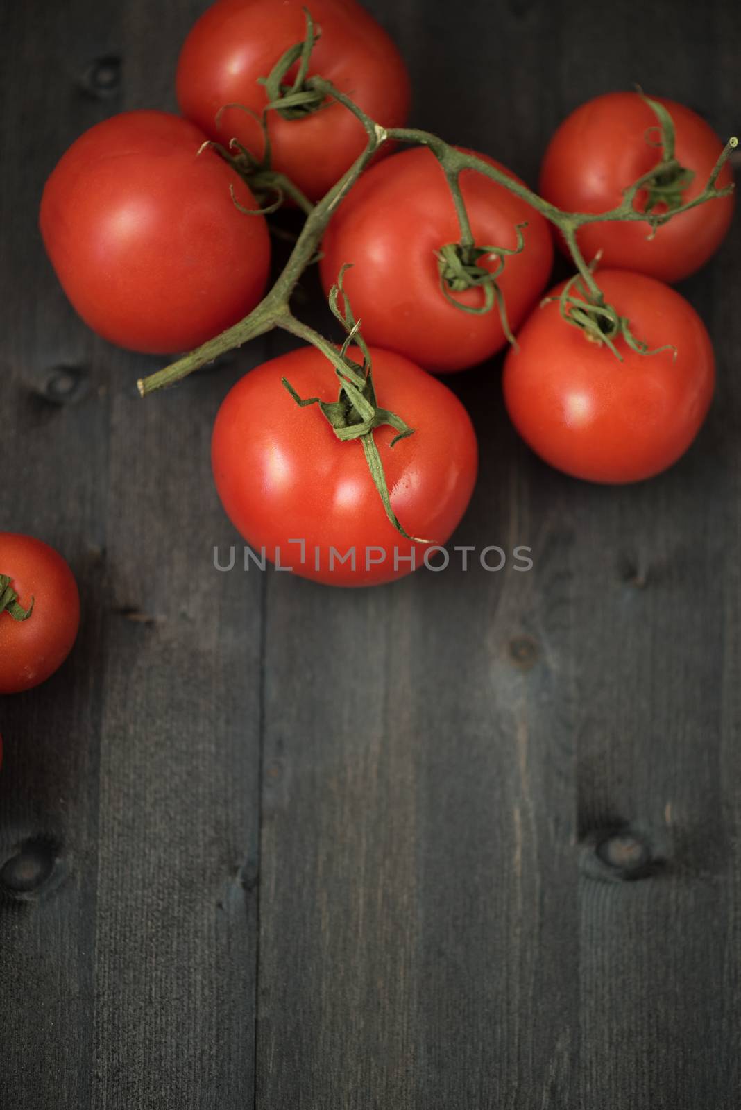 Fresh tomatoes on vintage wooden table