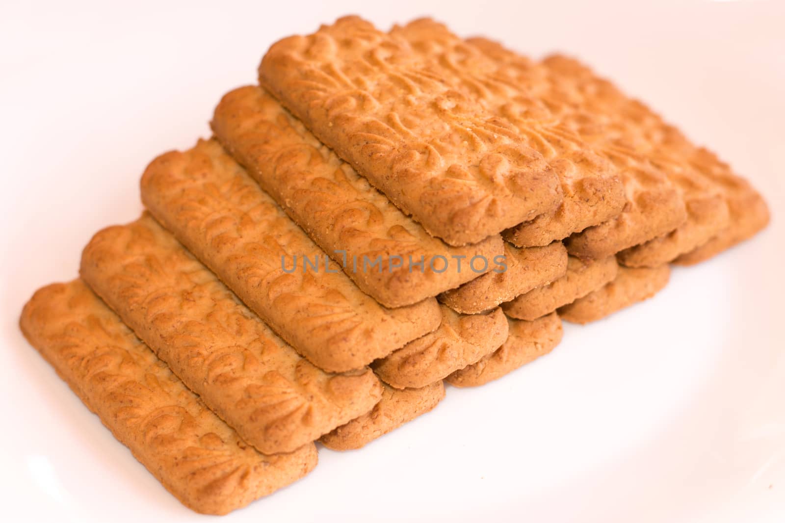 Fifteen biscuits put on a pyramid shape, isolated on white background.
