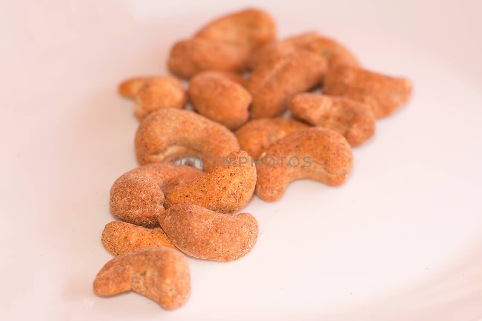 Flavored cashews isolated on white background.