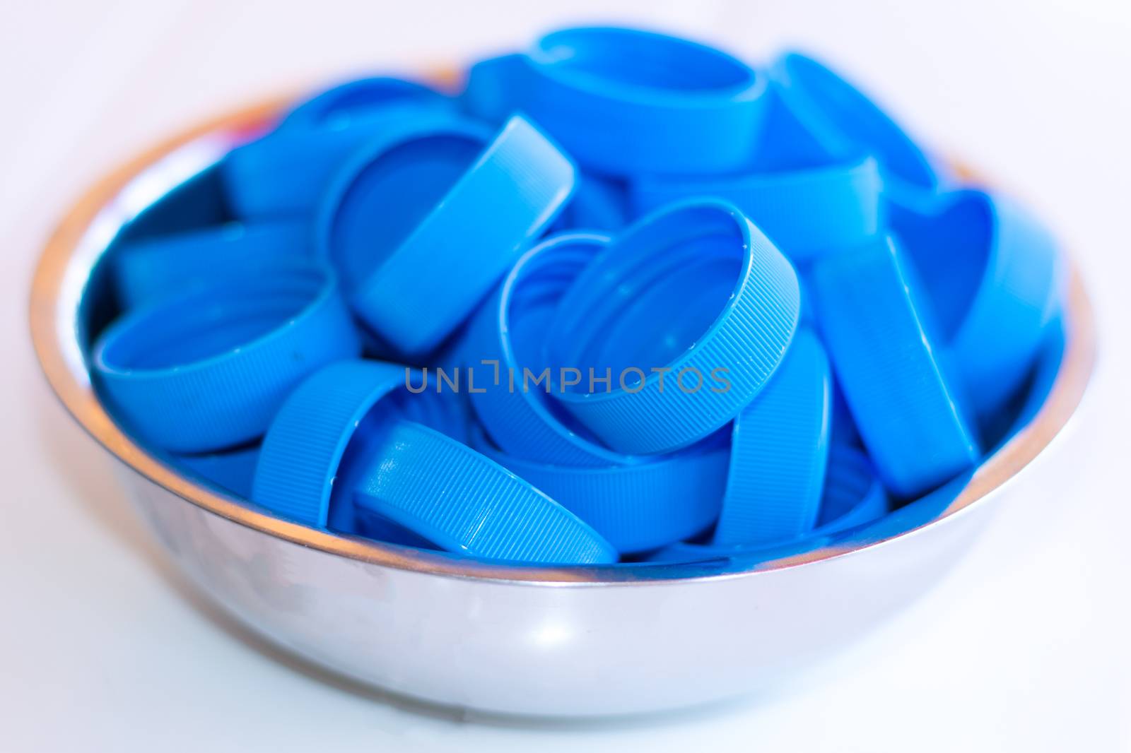 One stack of bottle caps, isolated on white background.
