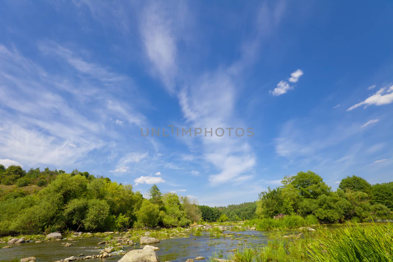 Bue sky with clouds over river. Nature in vibrant color