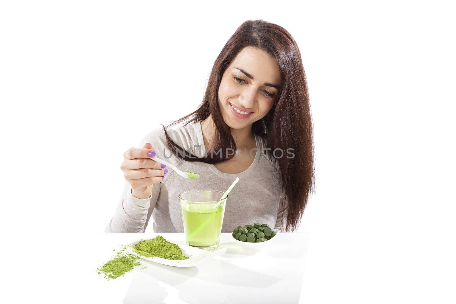 Detox. Beautiful girl with green drink in hand isolated on white. Spirulina, chlorella and wheatgrass. Healthy lifestyle, detox.