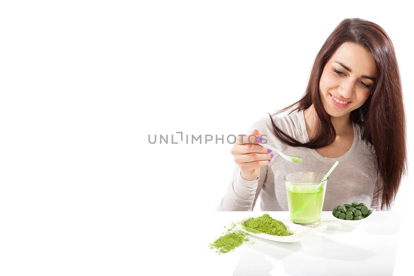 Detox. Beautiful girl with green drink in hand isolated on white. Spirulina, chlorella and wheatgrass. Healthy lifestyle, detox.