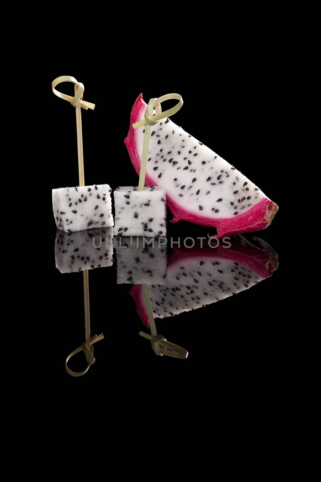 Luxurious dragon fruit isolated on black background. Tropical fruit, luxurious minimal style. 