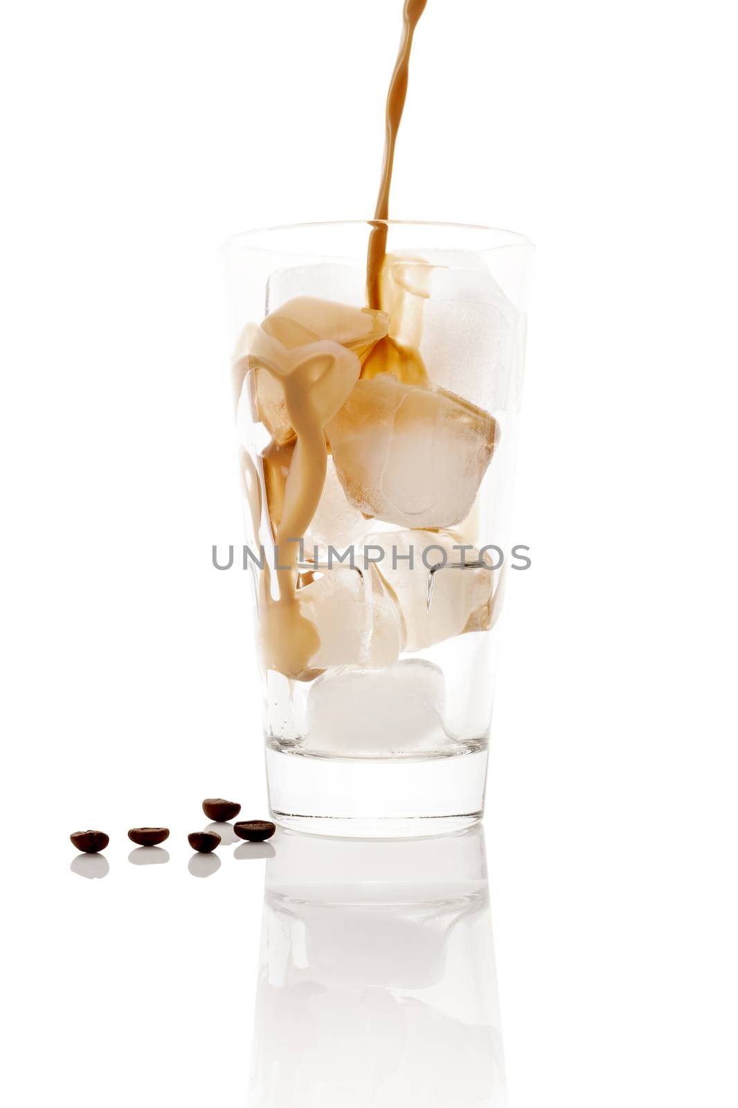 Pouring ice coffee into glass with ice cubes isolated on white background. Culinary coffee drinking. 