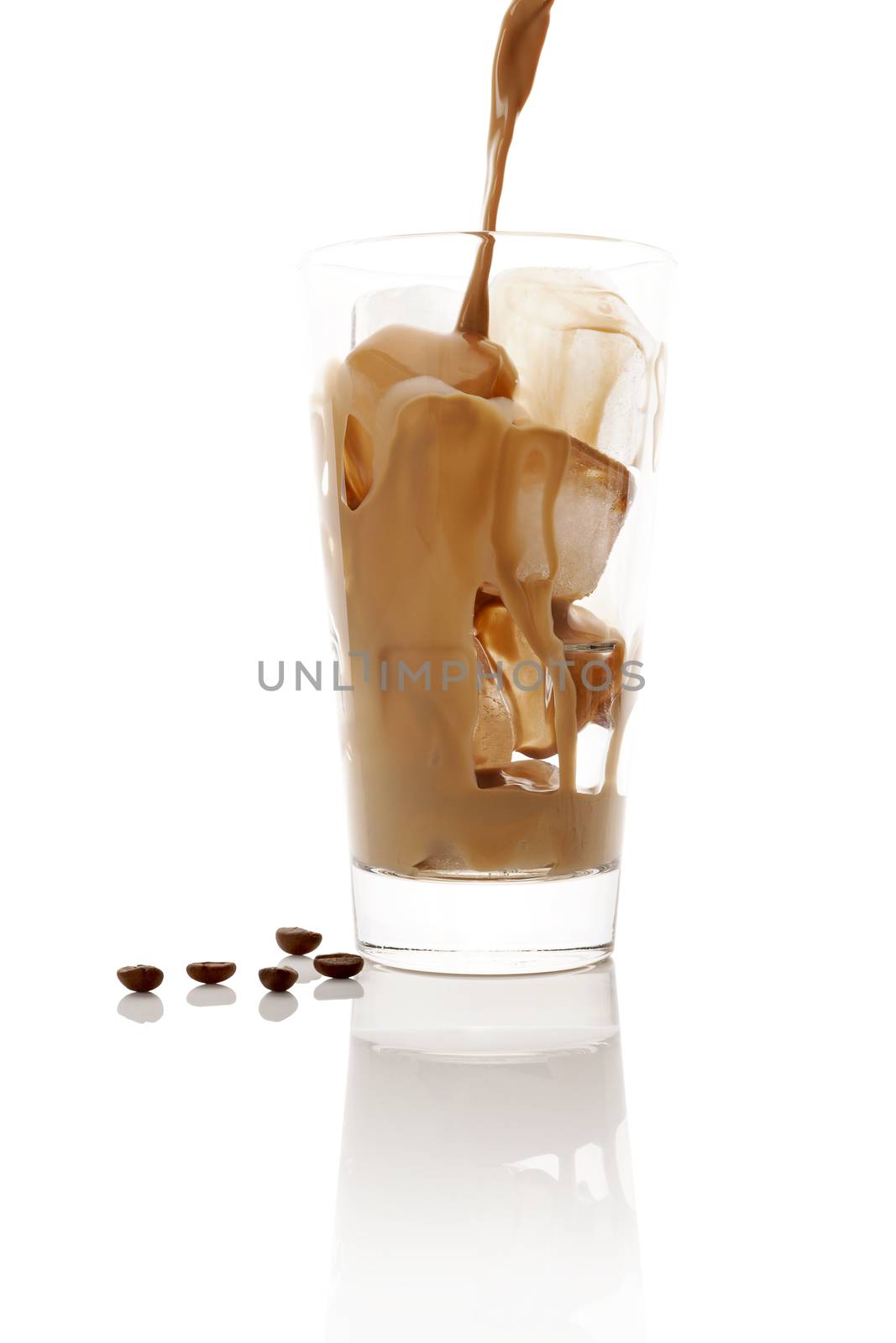 Pouring ice coffee into glass with ice cubes isolated on white background. Culinary coffee drinking. 