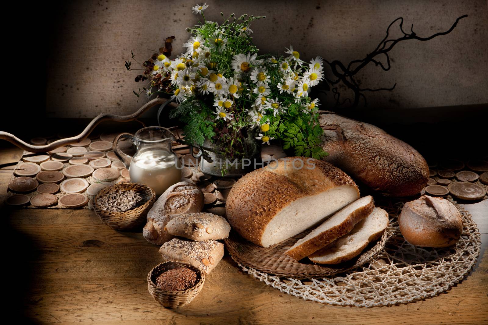 Still life with bread, milk and camomiles