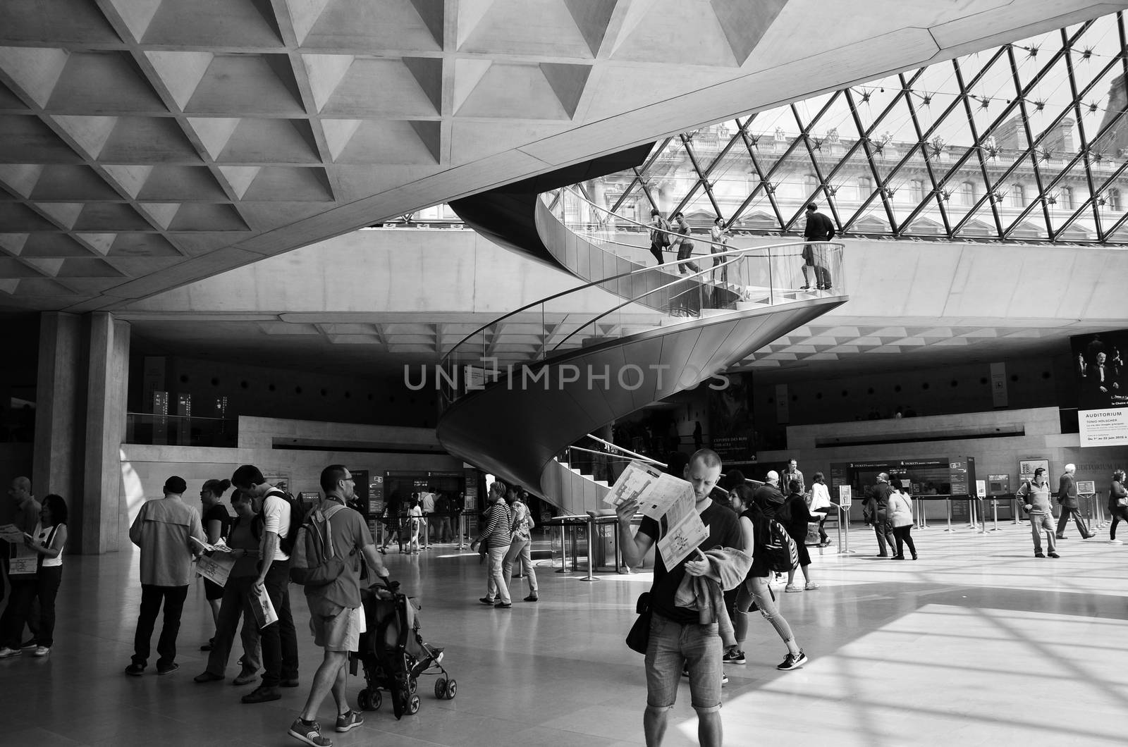 Paris, France - May 13, 2015: Tourists visit Interior of Louvre  by siraanamwong