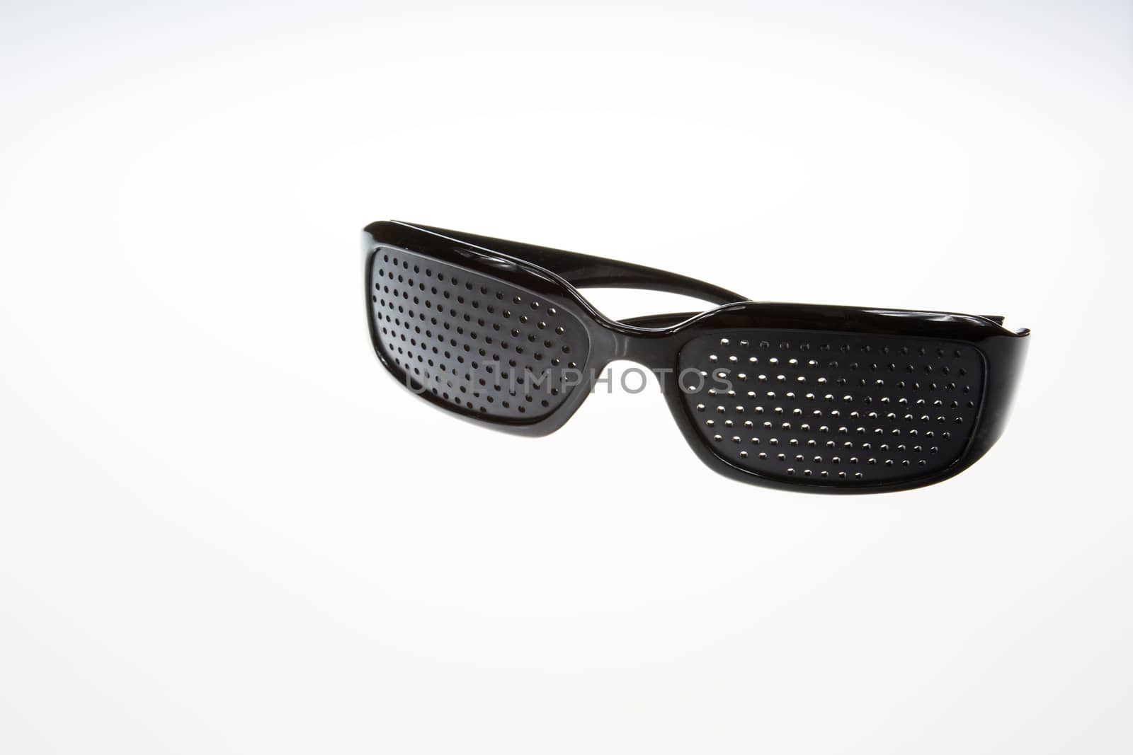 Black pinhole glasses on isolated white background.Close,horizonta view.