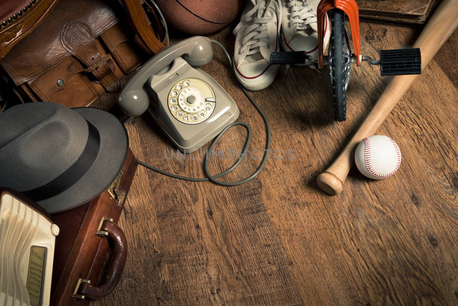 Group of assorted vintage items on hardwood floor at flea market.