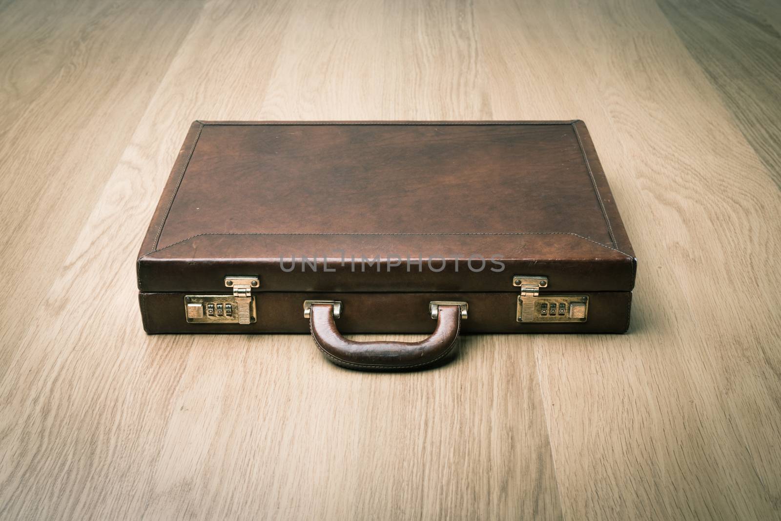 Leather briefcase on the floor by stokkete