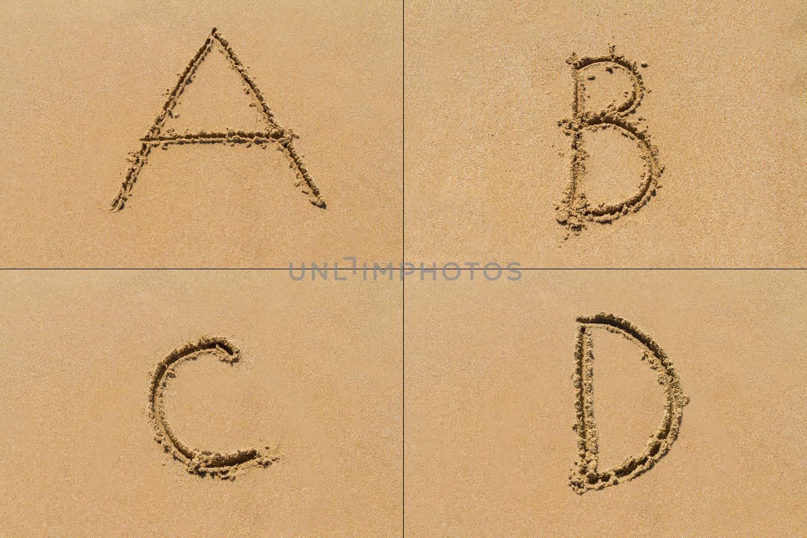 Conceptual set of A B C D letter of the alphabet written on sand with upper case.