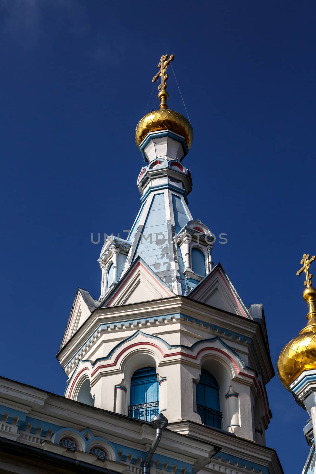 Close up view of Orthodox Ss Boris and Gleb Cathedral in Dougavpils, Latvia, on navy blue sky background.