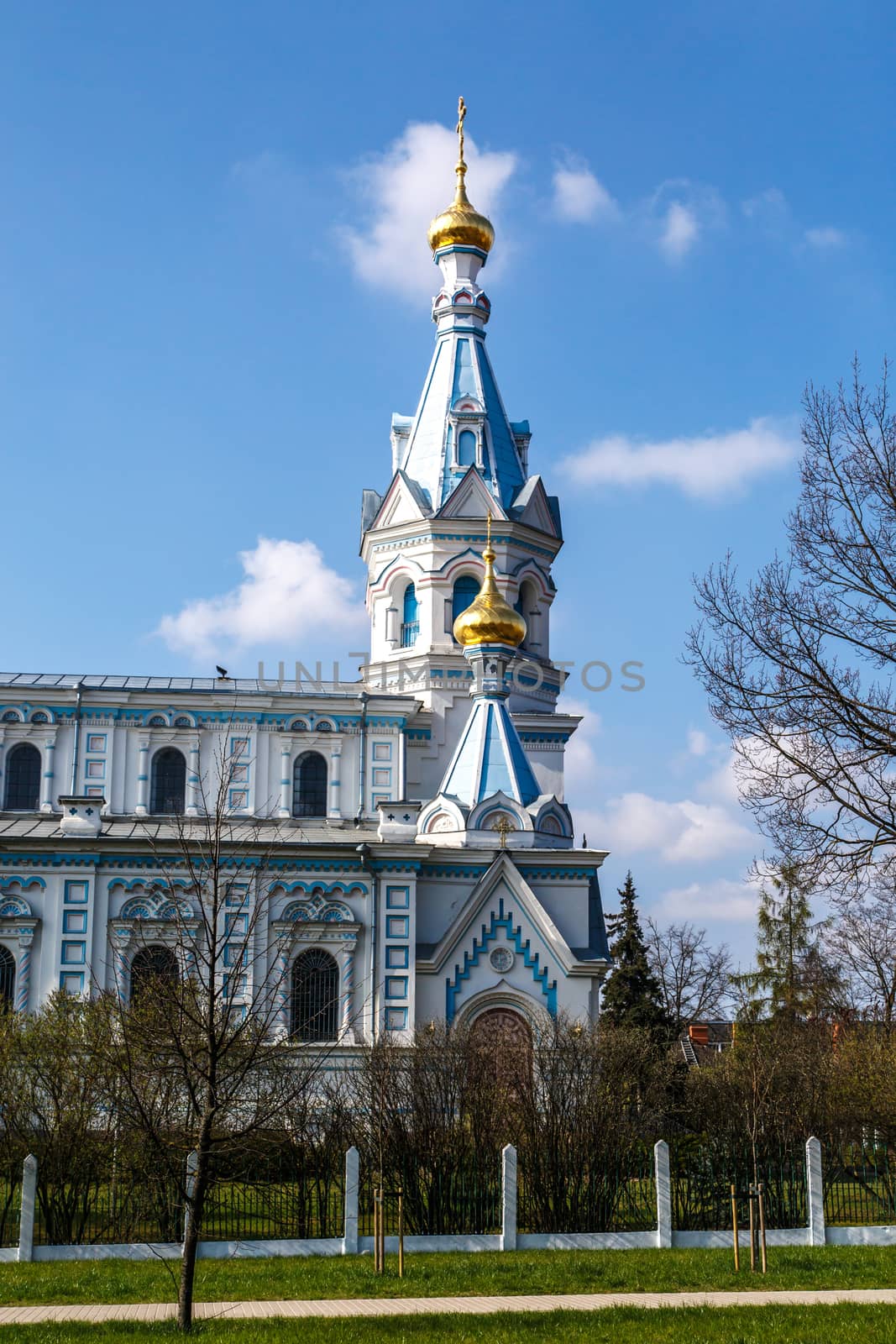 Front view of Orthodox Ss Boris and Gleb Cathedral in Dougavpils, Latvia, on blue cloudy sky background.