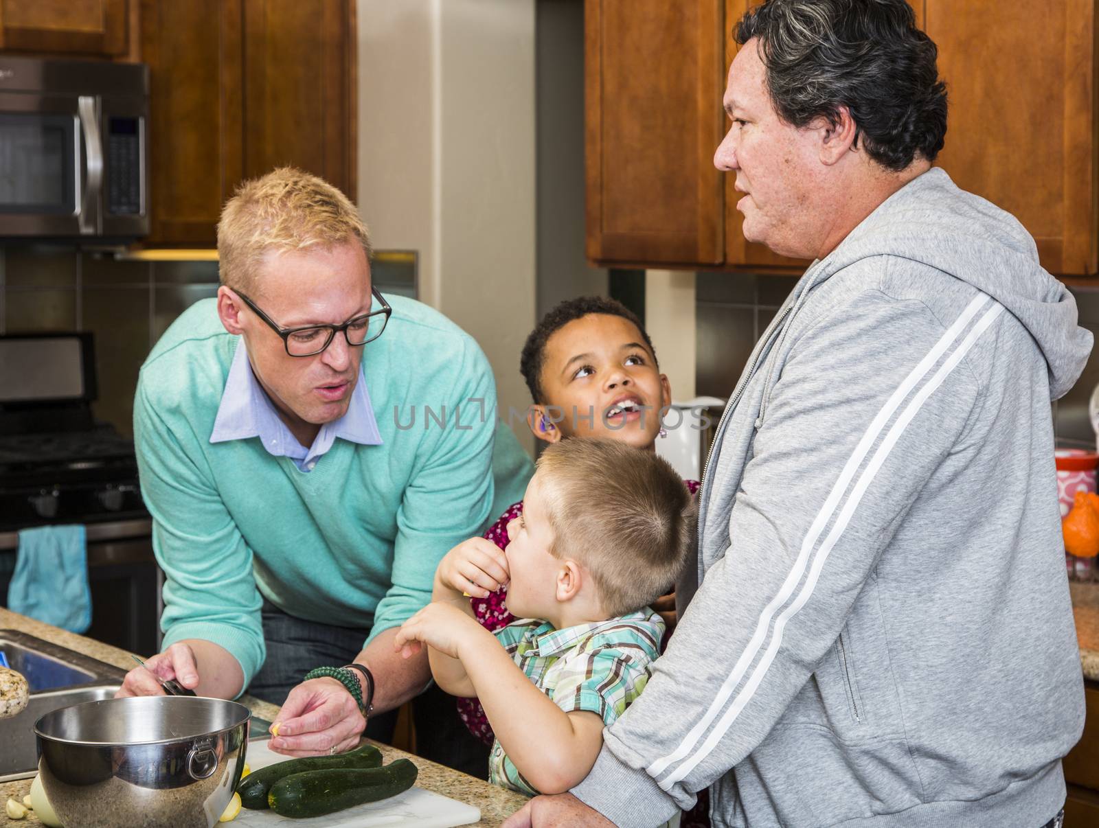 Preparing a meal with gay couple and kids in their home kitchen