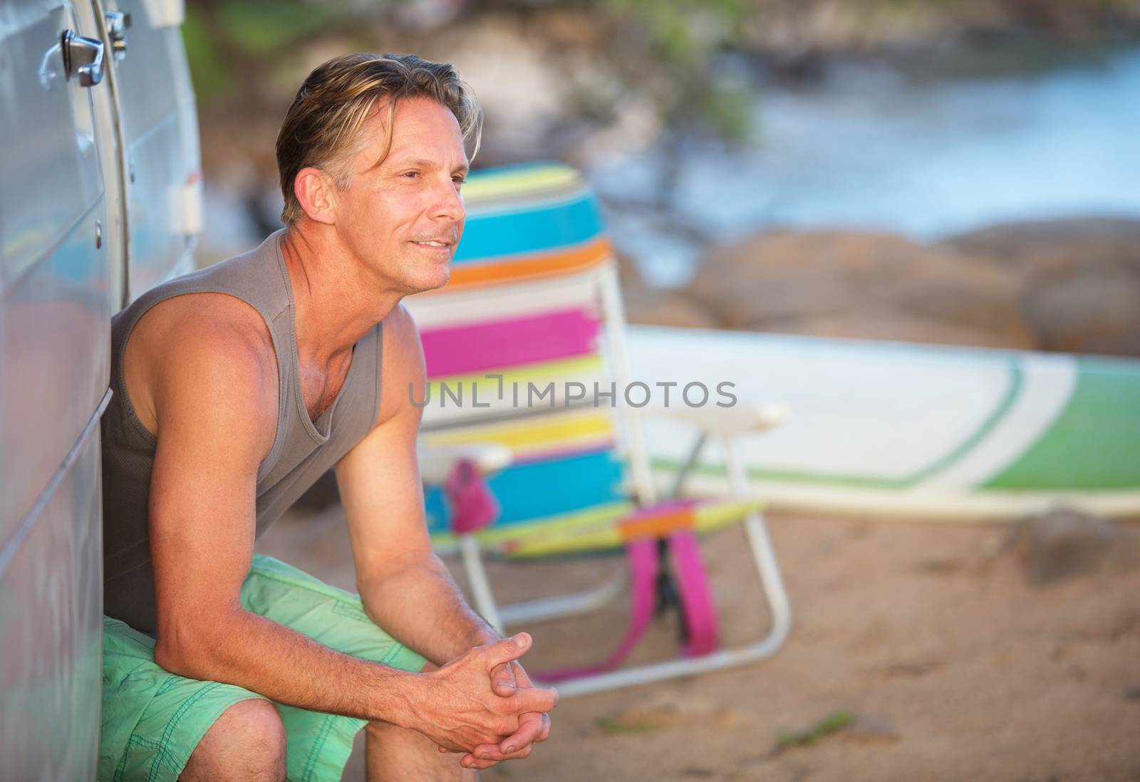 Single cheerful adult Caucasian male outdoors at beach