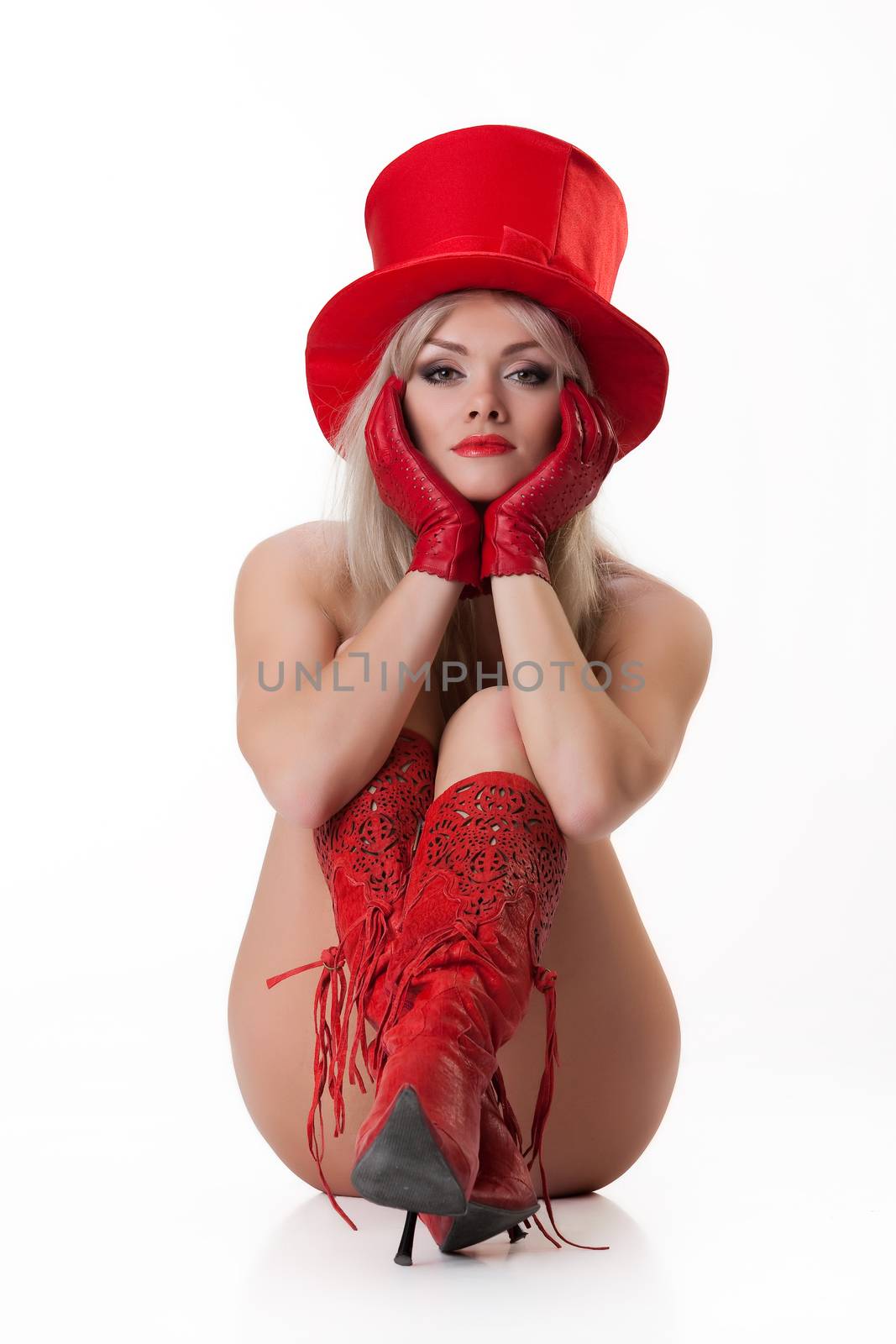 Young nude woman in red boots on isolated background