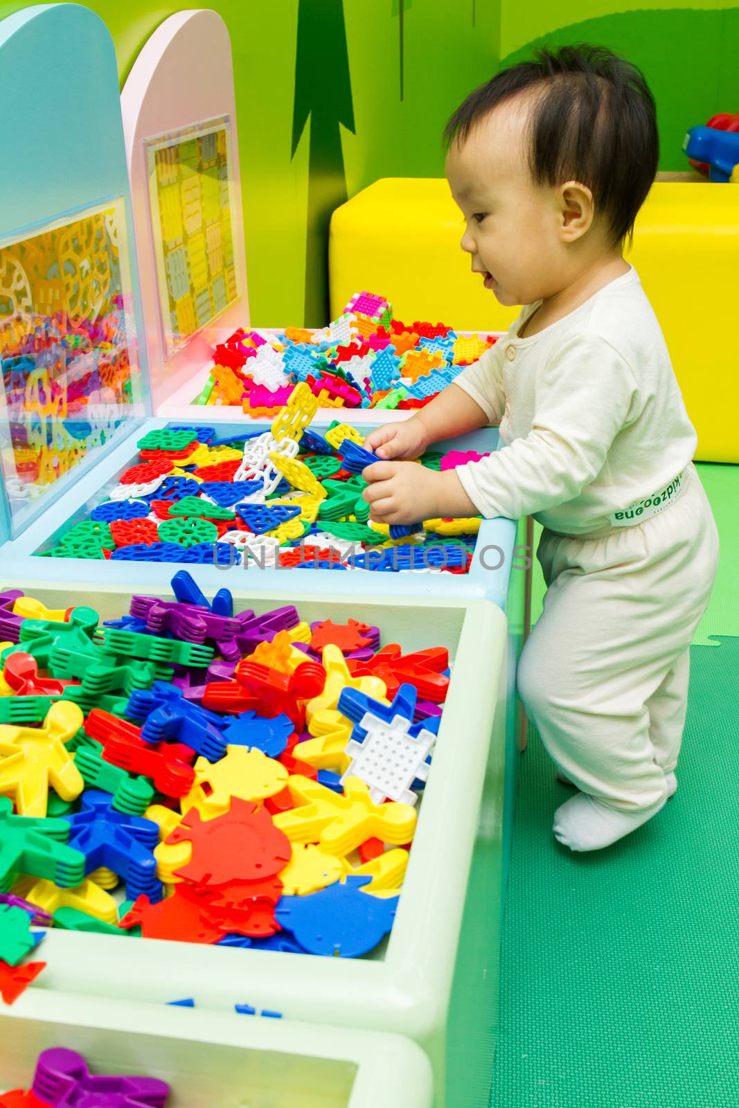 Chinese baby playing puzzle by kiankhoon