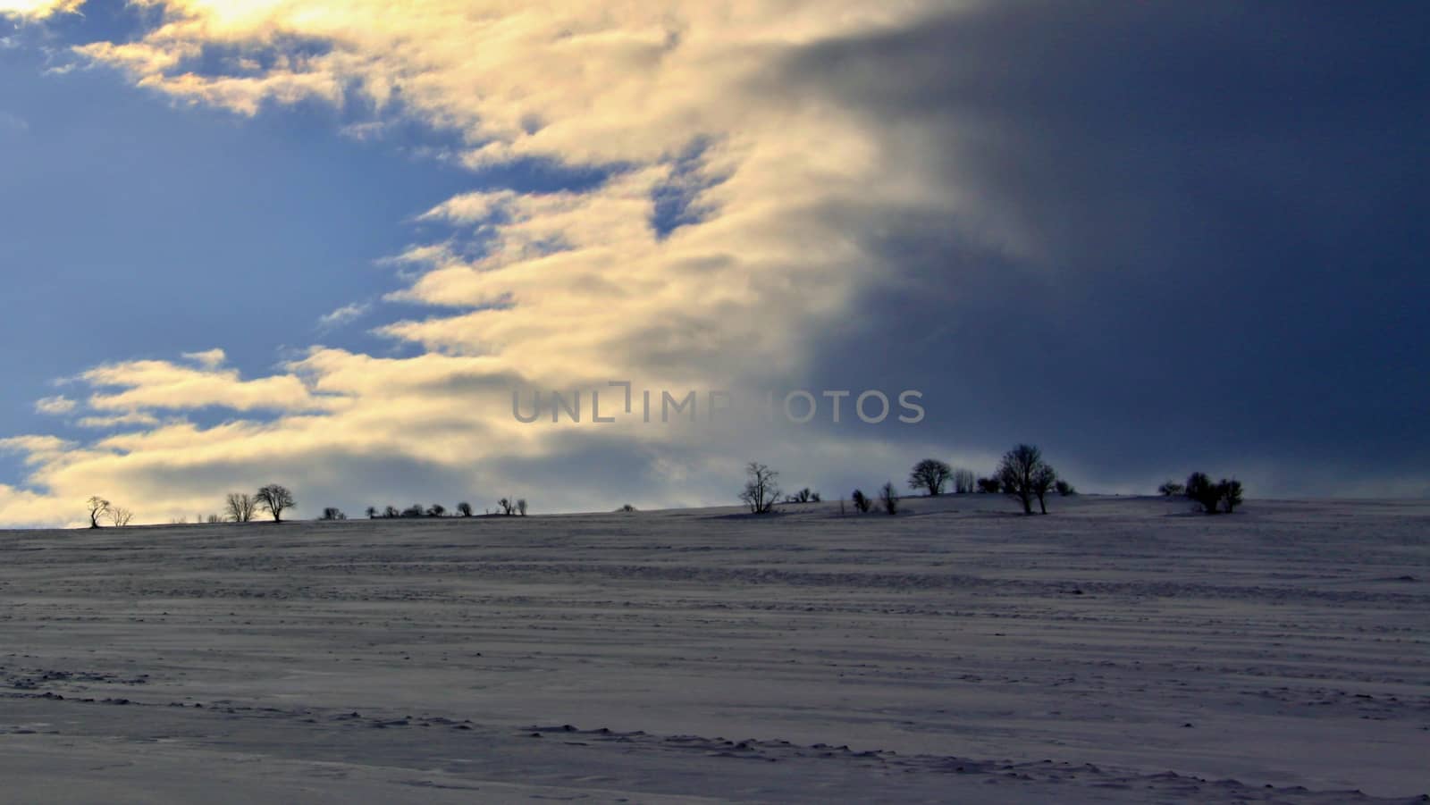 winter landscape and  gloomy sky in sunset