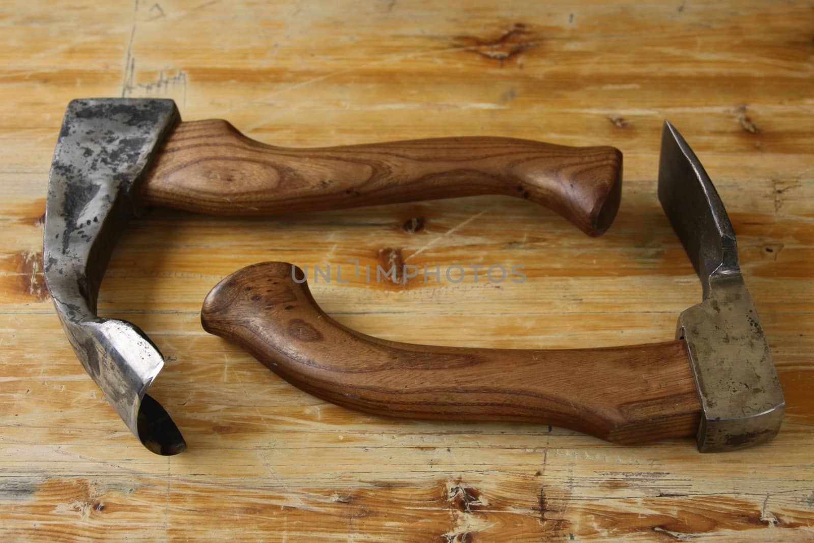 tools of a carpenter - axe and chisel on wood background