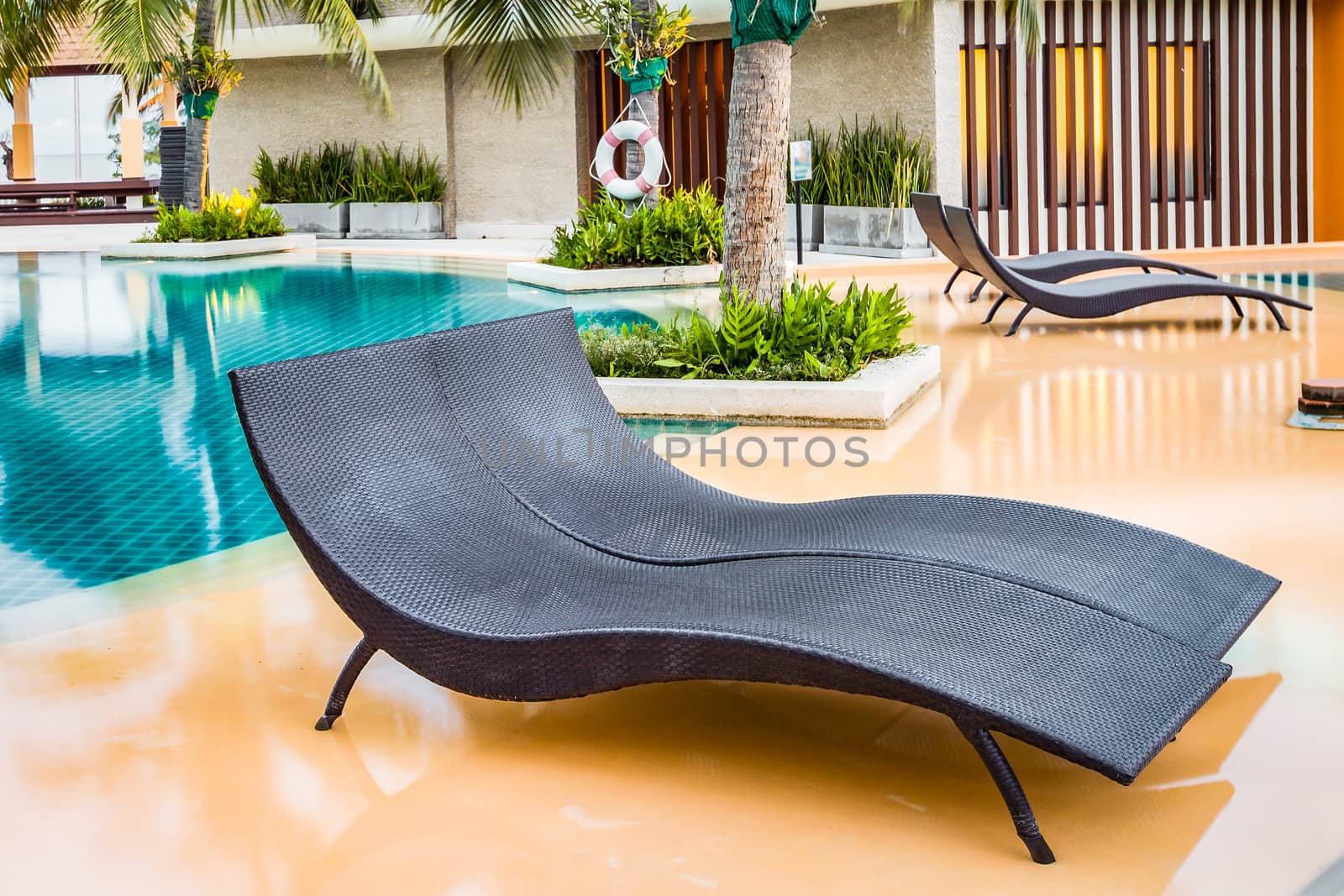 Beach chairs near swimming pool in hotel