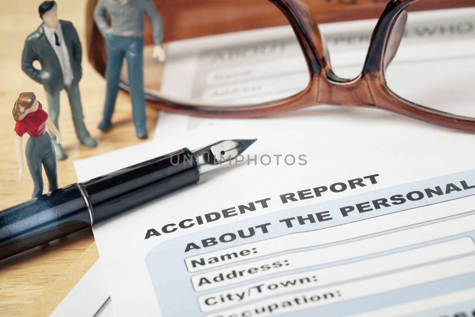 Accident report application form and pen on brown envelope and e by FrameAngel