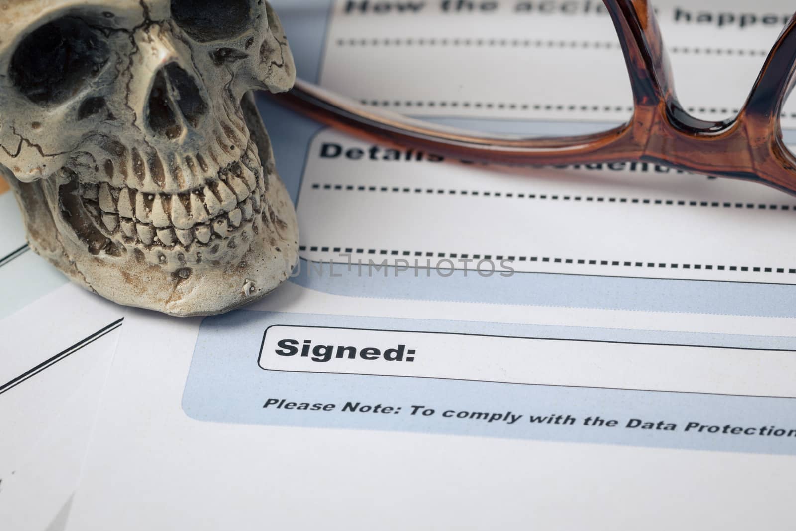 Signature field on document with pen and skull signed here; document is mock-up