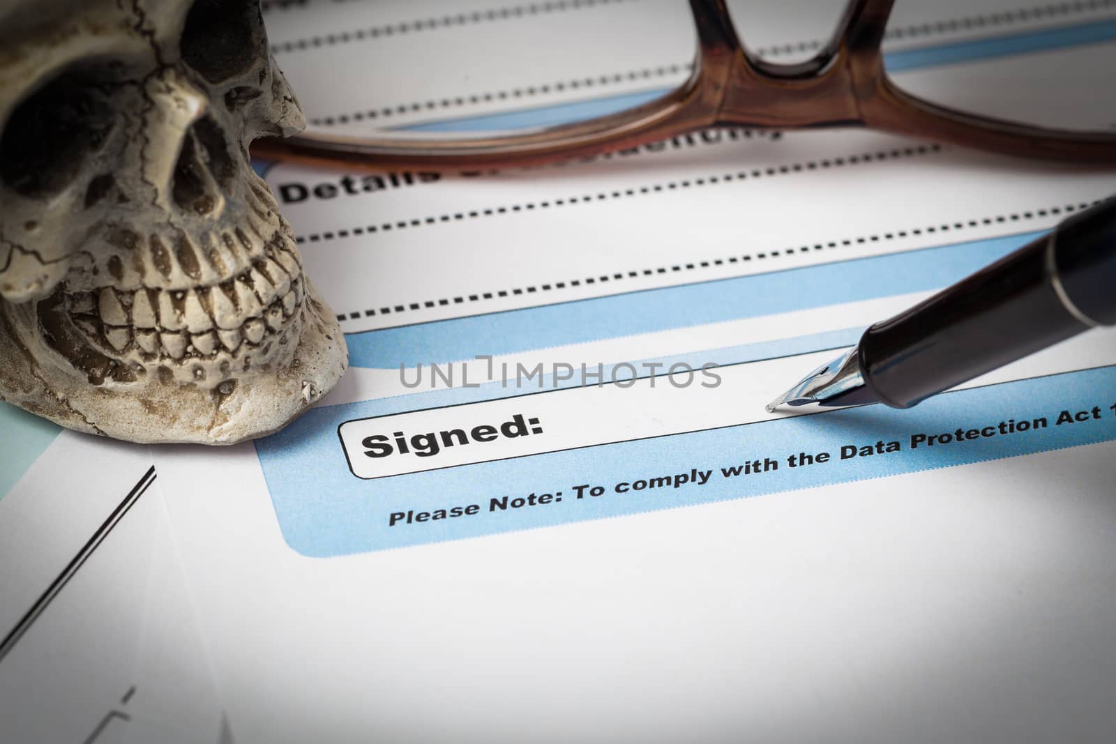 Signature field on document with pen and skull signed here; document is mock-up