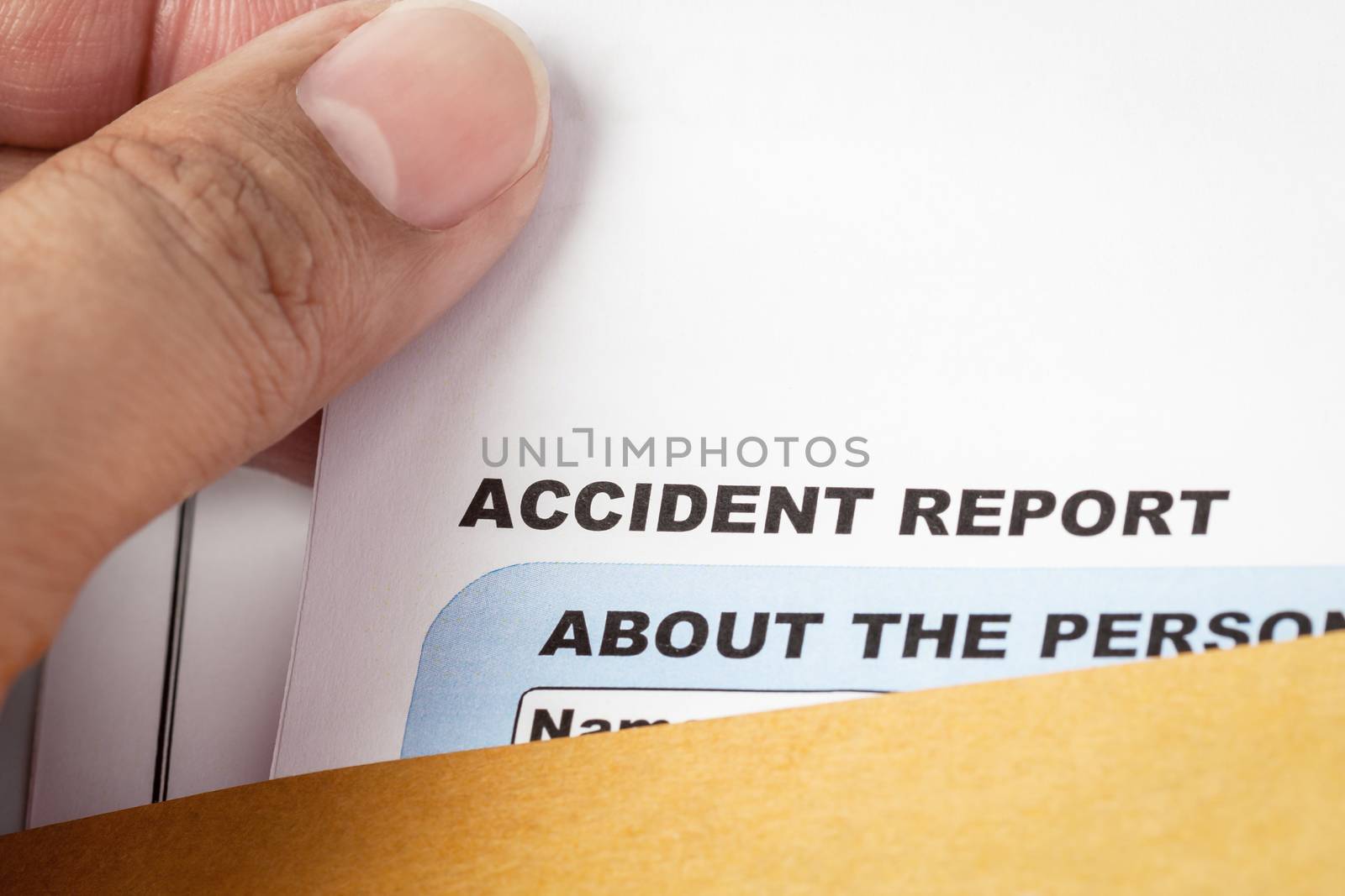 Accident report application form and pen on brown envelope and e by FrameAngel