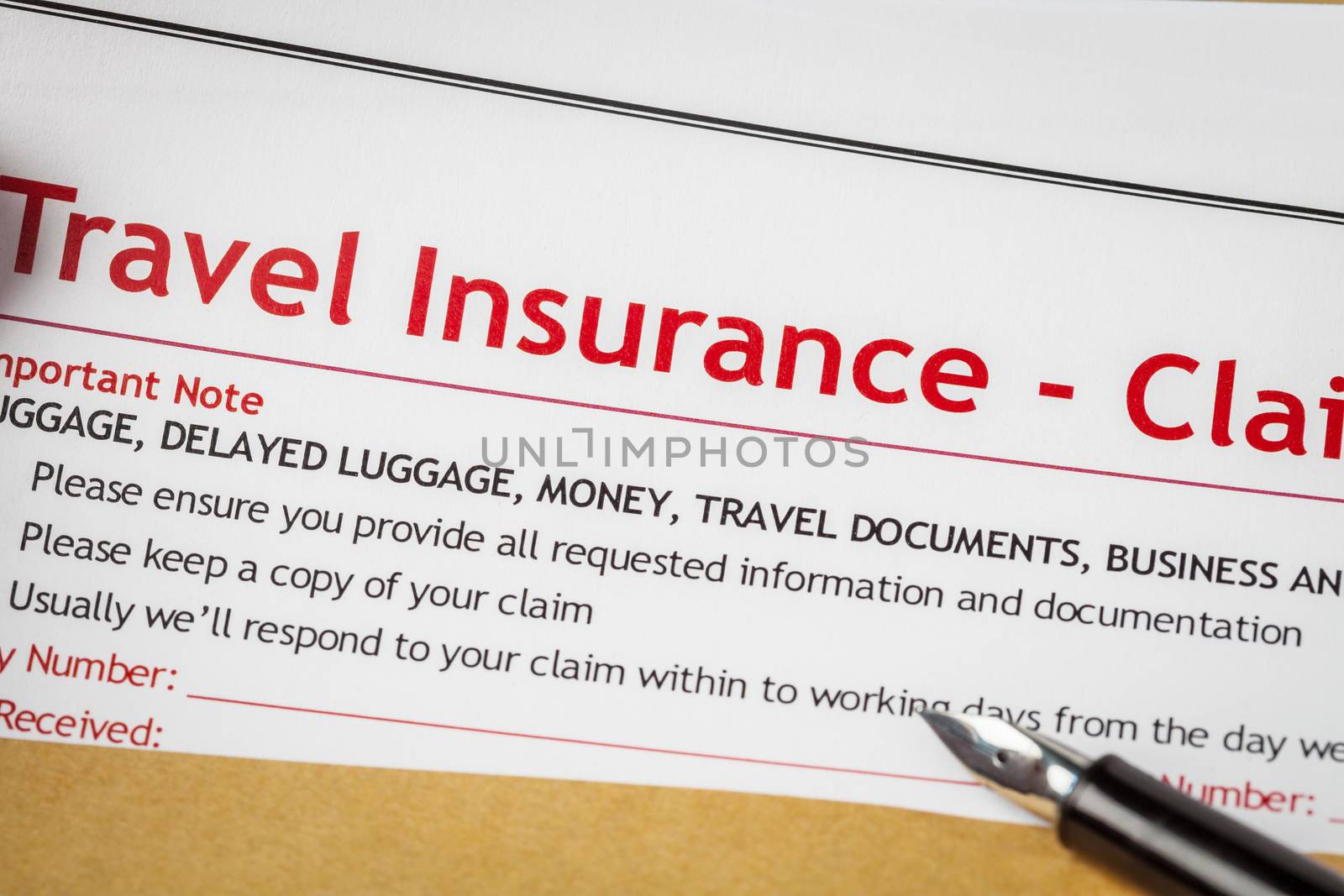 Travel Insurance Claim application form and human hand with pen  by FrameAngel