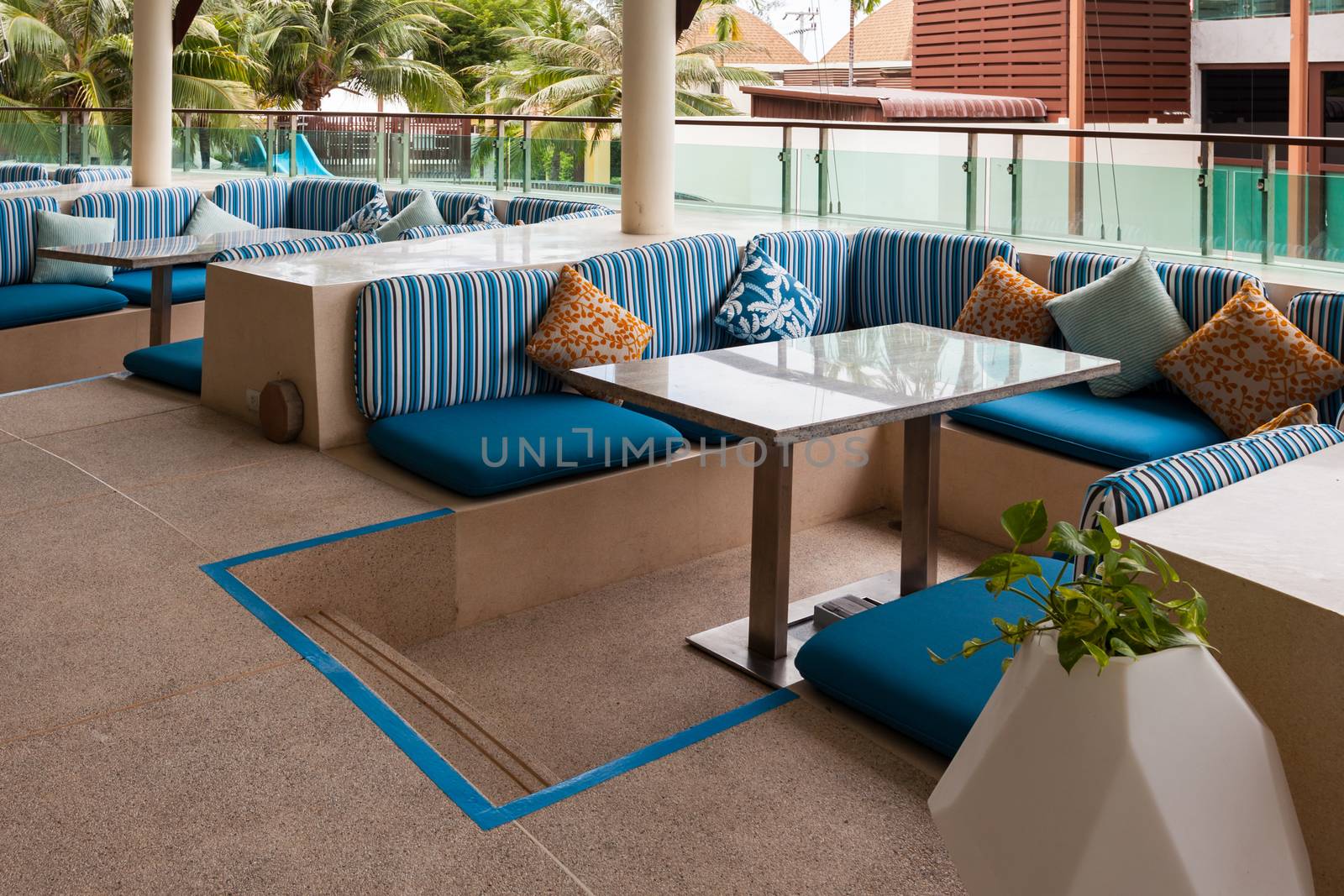 Restaurant dining table and pillow on terrace outside