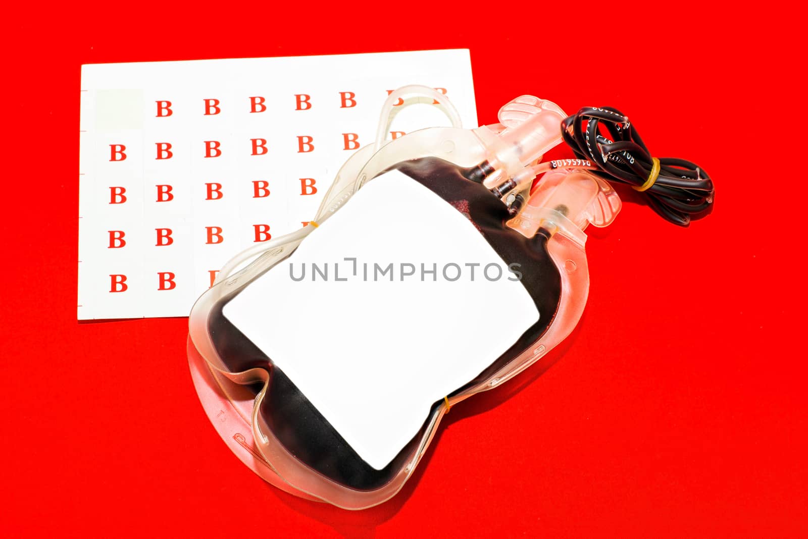 Close up bag of blood and plasma group B isolated on Red background