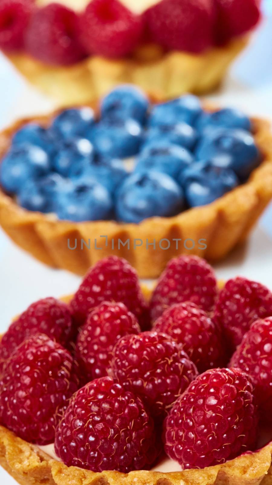 fruit tartlets with raspberries and blueberries. with copy space
