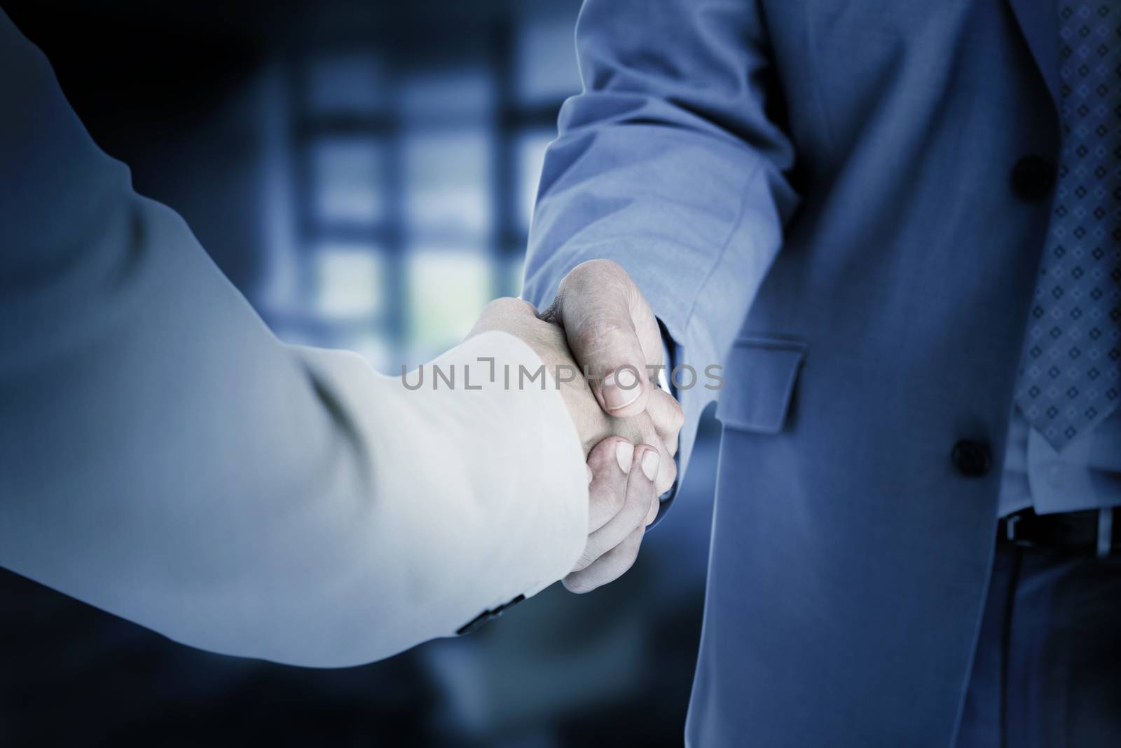 People in suit shaking hands against college