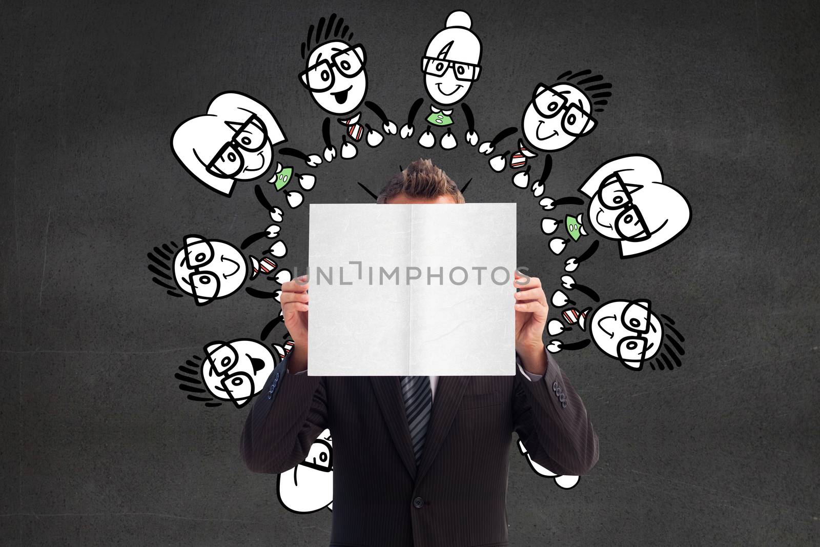 Businessman holding a white card in front of his face against black wall