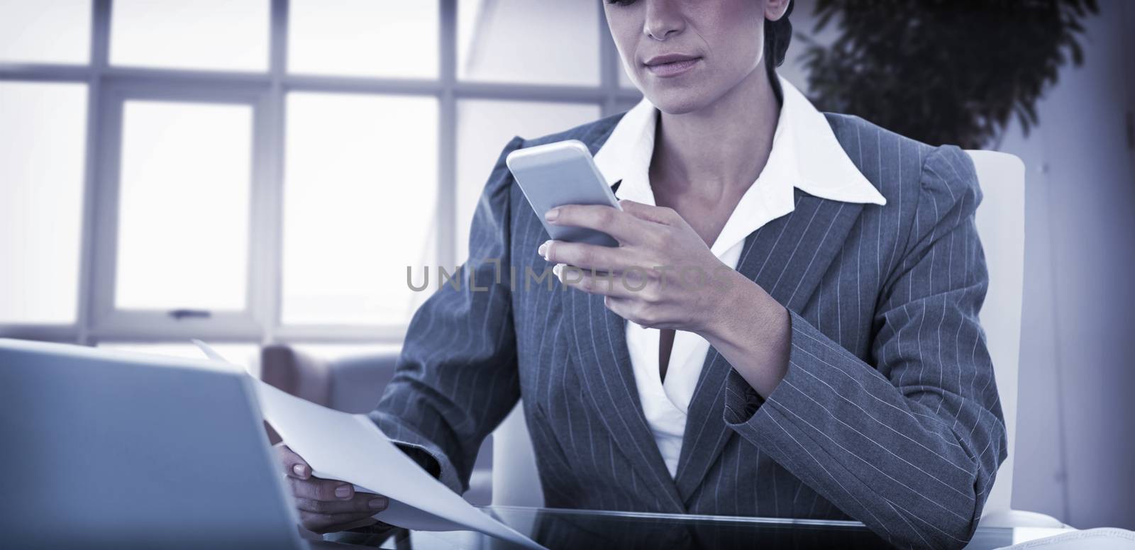 Businesswoman using her smartphone in an office