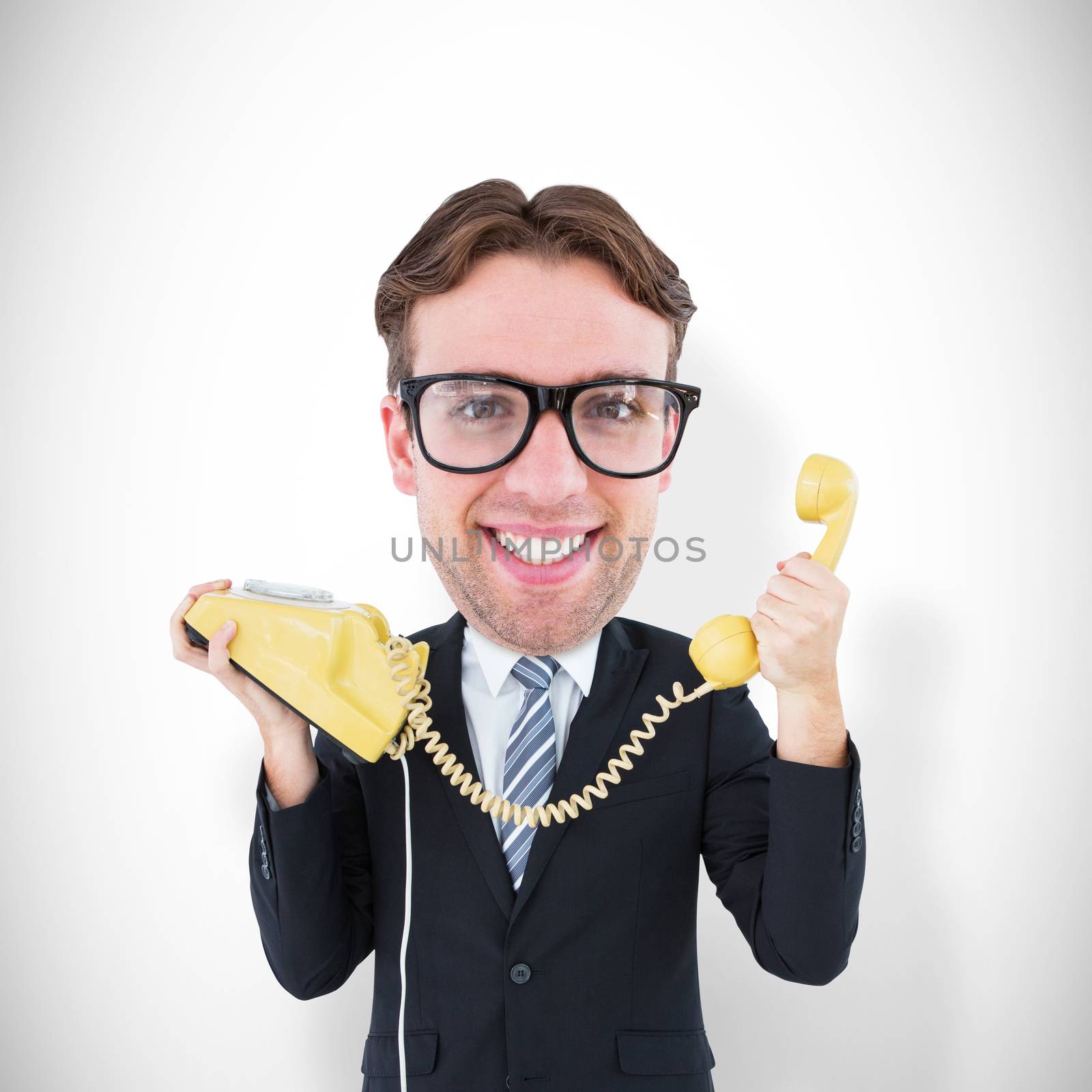 Geeky businessman holding phone against white background with vignette