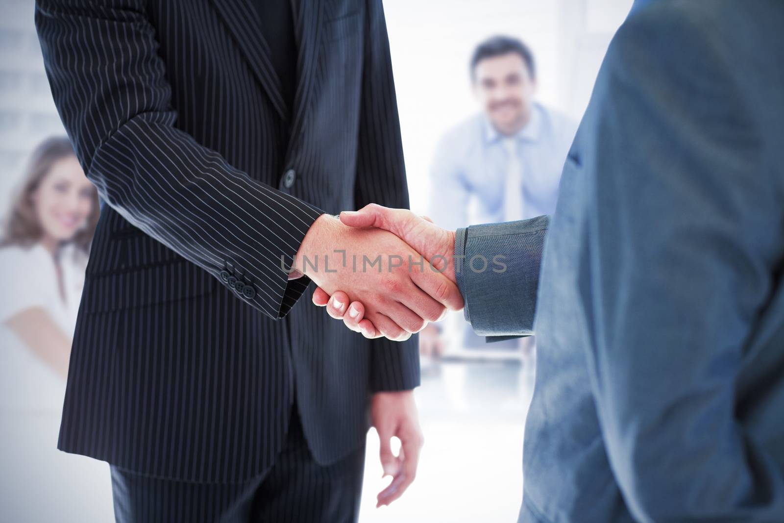 Composite image of business people shaking hands by Wavebreakmedia