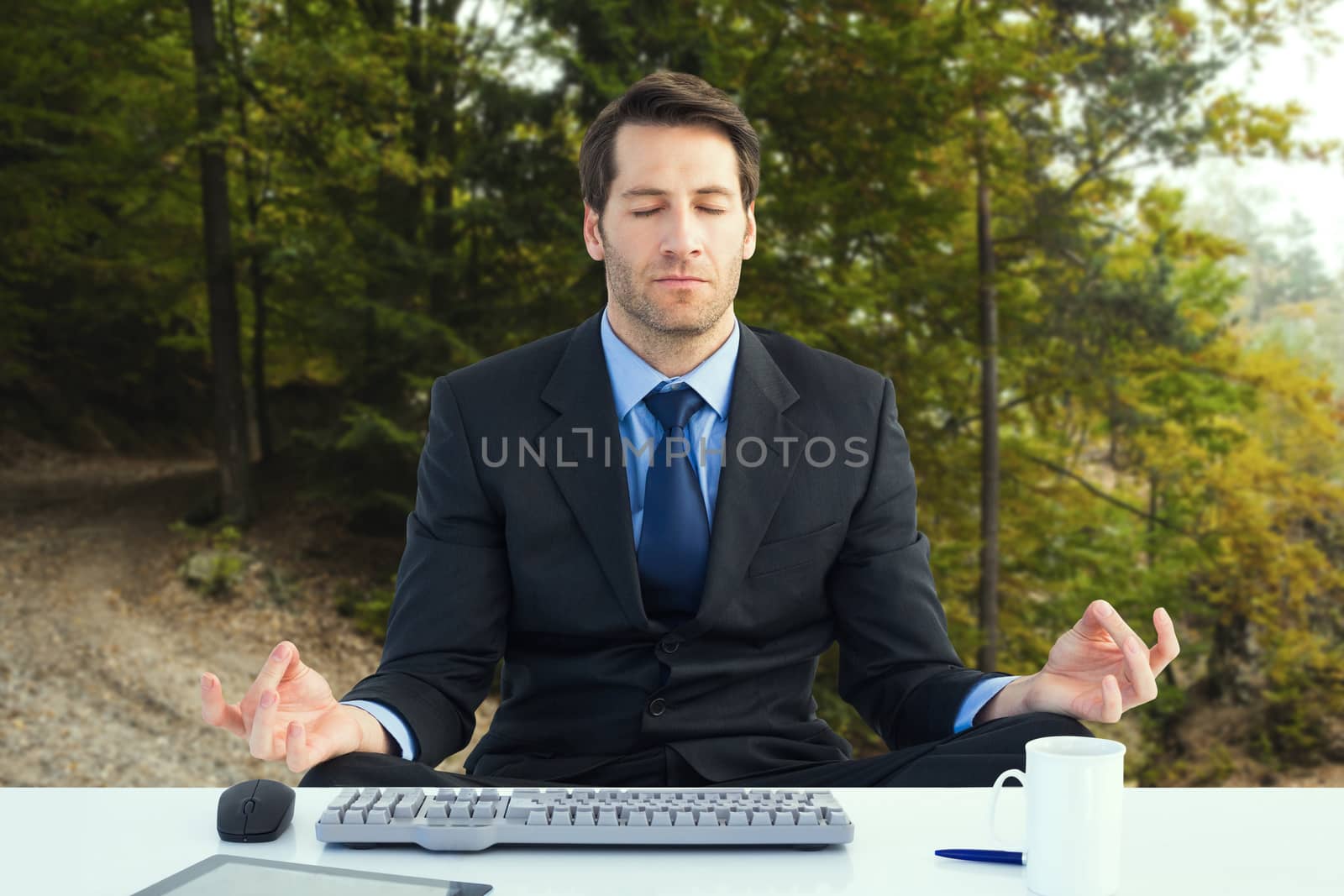 Composite image of calm businessman sitting in lotus pose by Wavebreakmedia