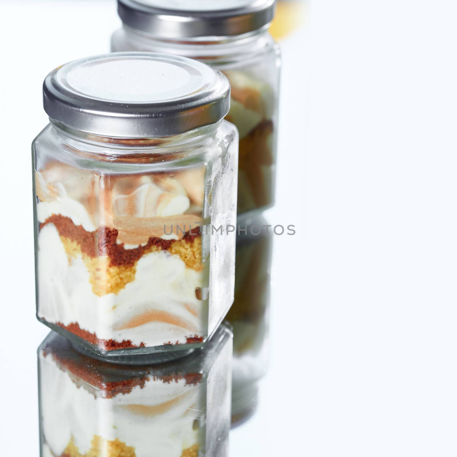 Cheesecake in a glass on a mirror with copy space