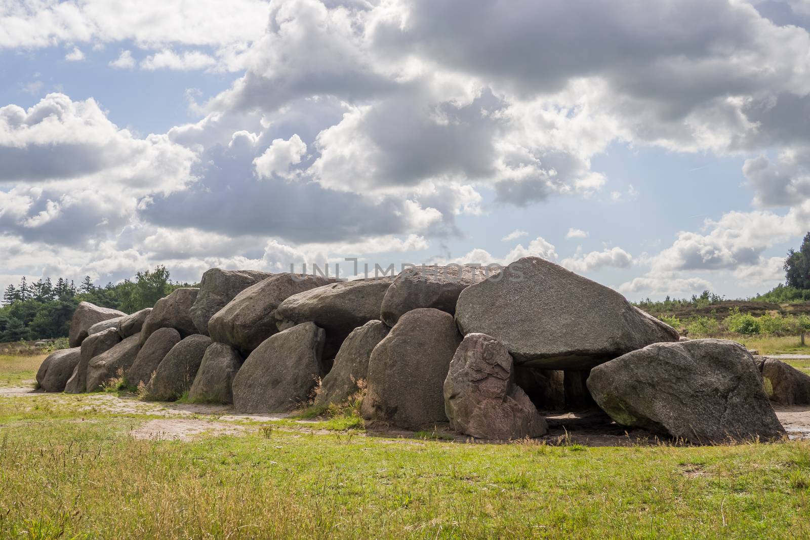Sunny HDR of megalithic stones in Drenthe, Netherlands, with a dramatic sky above